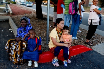 Program Image: Two families waiting at the bus stop